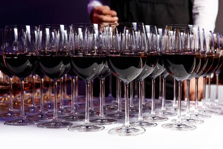 Red wine glasses at a partyの写真素材