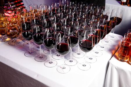 Red wine glasses at a partyの写真素材