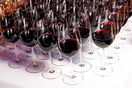 Red wine glasses at a partyの写真素材