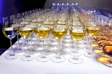 Elegant glasses with white wine at a partyの写真素材