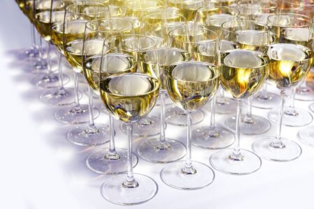 Elegant glasses with white wine at a partyの写真素材