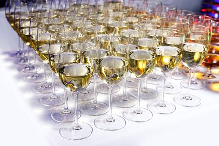 Elegant glasses with white wine at a partyの写真素材