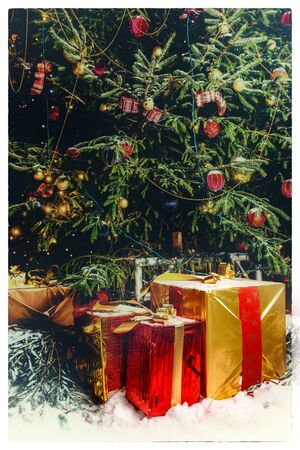 Beautiful decorated christmas tree with present boxes in a winter concept with snow. Postcardの写真素材