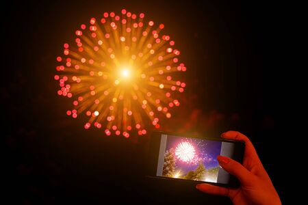 Shoots fireworks video on smartphoneの写真素材