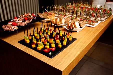 Mini canapes food.Beautiful decorat catering banquet table. Snacks and appetizers. Wedding celebrationの写真素材