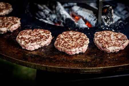 Fresh meat cutlets in a frying pan grill. Cooking a grilled burgerの写真素材