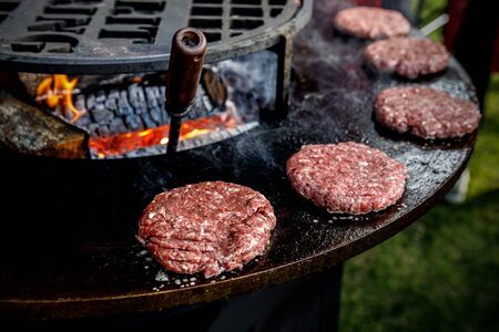 Fresh meat cutlets in a frying pan grill. Cooking a grilled burgerの写真素材