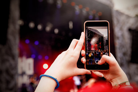 Smartphone in hands on music show