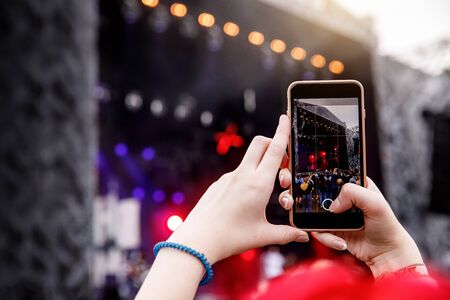 Smartphone in hands on music showの写真素材