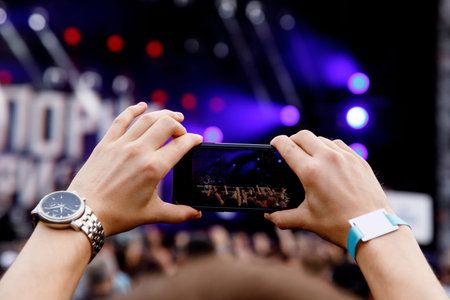 Smartphone in hands on music show