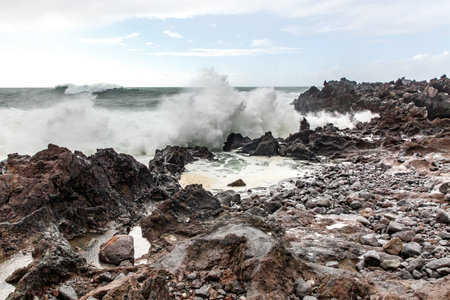 Big waves crashing near a rocky shore. Ocean stormの写真素材