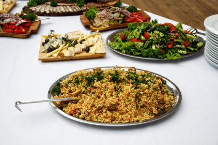 Plate of pilaf on a table with a white tablecloth.