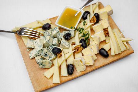 Tasting cheese dish on a wooden plate.の写真素材
