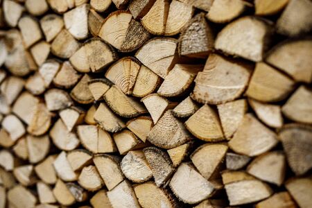 Wall of stacked wood logs as background. Pile of wood logs ready for winter.の写真素材