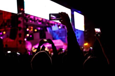 Silhouette of a smartphone in the hands. Stage record videoの写真素材