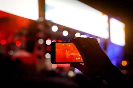 Silhouette of a smartphone in the hands. Stage record videoの写真素材