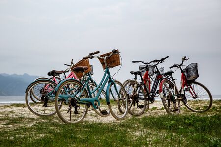 Walking bikes parked on the shoreの写真素材