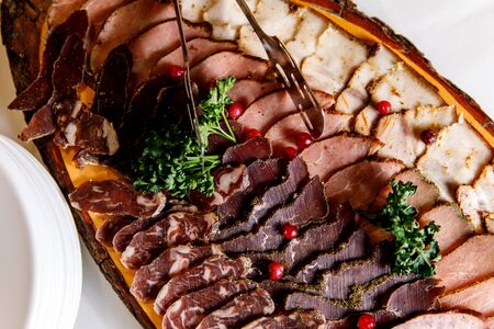 Cold smoked meat plate with prosciutto, salami, bacon and pork chopsの写真素材