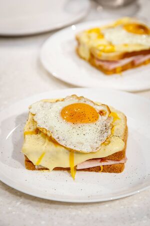 Sandwich with scrambled eggs on white plate. Morning breakfastの写真素材