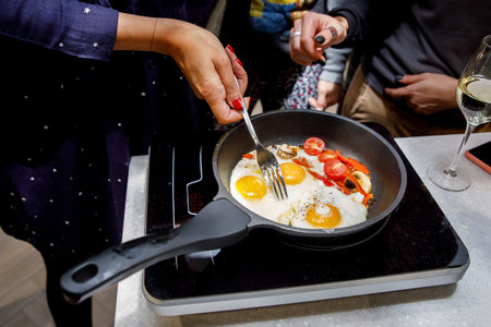 Scrambled eggs and onions on frying pan