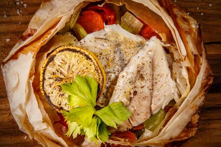 Oven-baked fish with lemon in a crispy plate made from pastryの写真素材