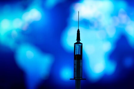 Medical syringe for a vaccine. Blue backgroundの写真素材