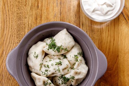Homemade Meat Dumplings with sour cream - russian pelmeni in a plateの写真素材