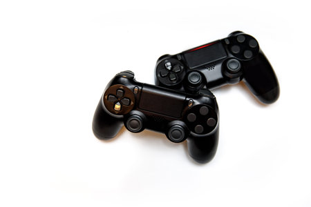 Two gaming controllers for playing video games on a white background.