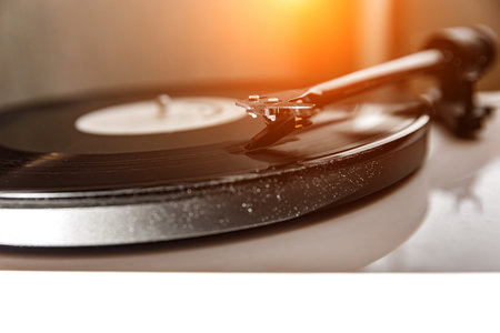 Playing an old vinyl. Dust on the turntable. Needle close-up