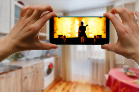 Watching online concert at home by smartphone. Live stream music video