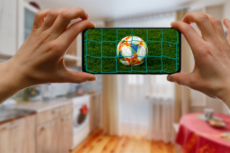 Minsk. Belarus - 20.04.2020: Watching EURO football game at home via smartphone. Broadcasting from...