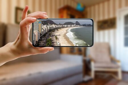 Tourism from home concept. Travel to Copacabana beach via smartphone