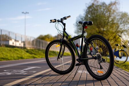 Bicycle on a bike path in the city. Wheel closeupの写真素材