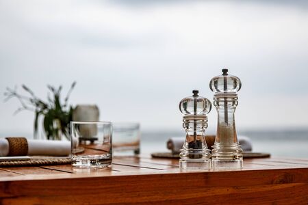 Pepper and salt shaker on the table of a coastal cafeの写真素材