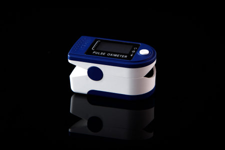Pulse oximeter on black background.