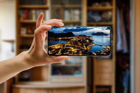 Norway city Aalesund on the screen. View famous tourist spots from home via smartphone. Online travel conceptの写真素材
