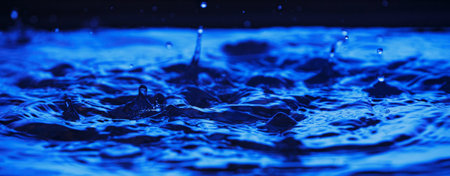 Blue water splashing. Liquid drops