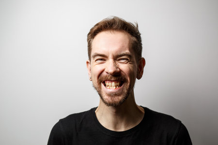 Portrait of smiling young man on gray backgroundの写真素材