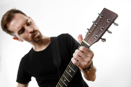 Guitarist playing a chord on a guitar fretboard close up