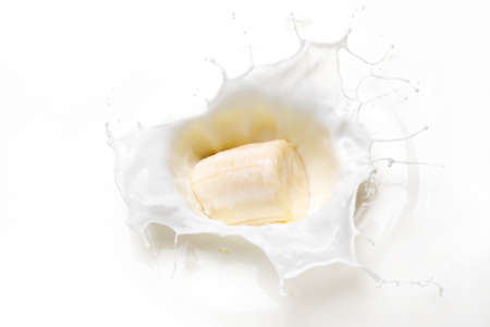 Banana slice in milk splashの写真素材