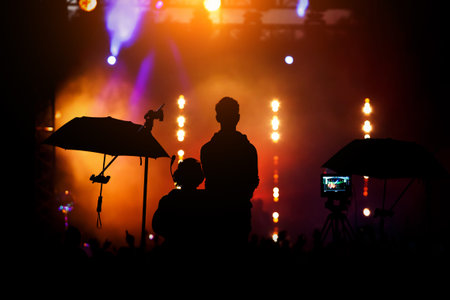 Crew team working to setting and preparing production for show event or music concert. Black...