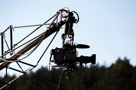 TV camera on a crane on a football match or concertの写真素材