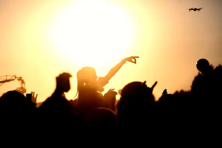 Silhouette of people on a big festival eventの写真素材