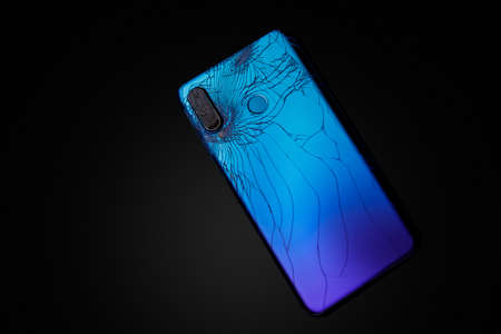 The back panel of a broken phone. Spoiled smartphone camera.の写真素材