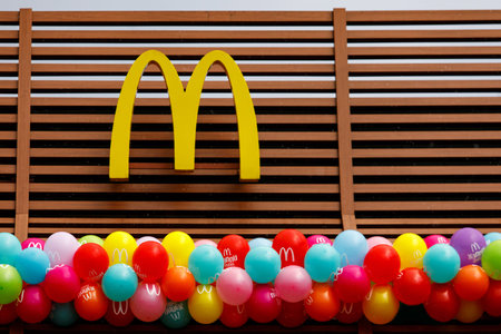 McDonald's logo on the new restaurant opening. Birthday concept. Balloons under the sign