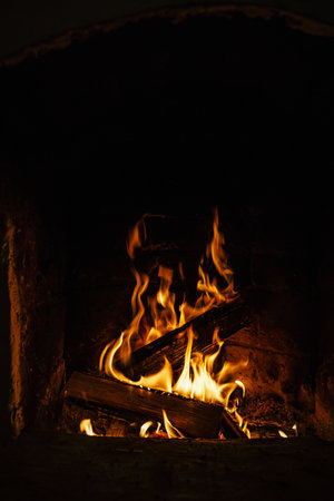 Village stove firewood and fire. Burning wood inside traditional ovenの写真素材