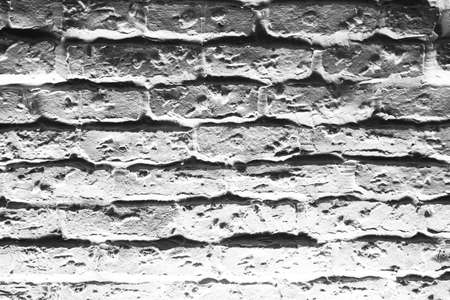Abstract weathered texture stained old stucco light gray and aged paint white brick wall background, low lightの写真素材