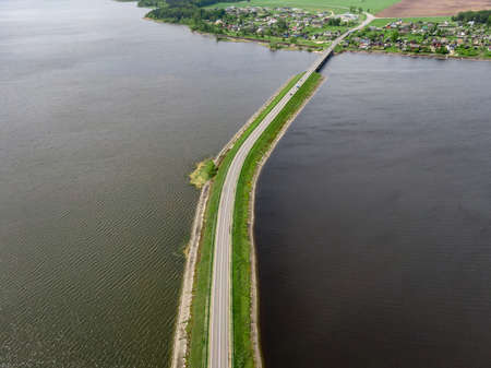 The road between two lakes. Nature bridge. Aerial viewの写真素材