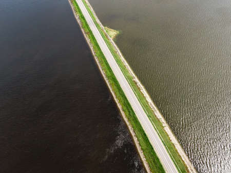 The road between two lakes. Nature bridge. Aerial viewの写真素材