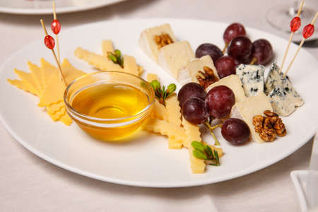 Cheese plate with grape and honeyの写真素材